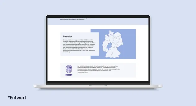 Ein Laptop auf hellblauem Hintergrund zeigt den grafischen Entwurf einer Webseite der hessischen Landesregierung.
